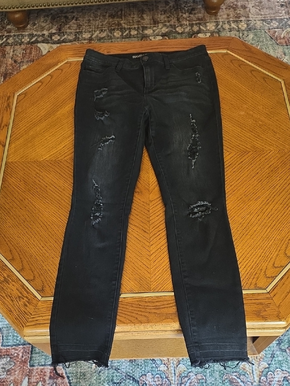 black Rampage skinny jeans with distressed details and frayed hems.
